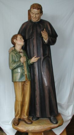 Statua di San Giovanni Bosco in legno con bambino